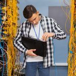 young-network-engineer-holding-ethernet-switches-min